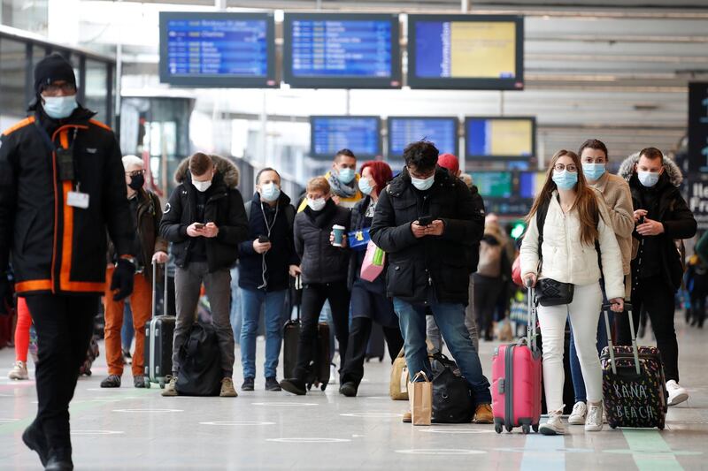 Passengers, wearing protective face masks, wait at Montparnasse railway station in Paris before a third lockdown imposed during a month-long on Paris and parts of the north after a faltering vaccine rollout and spread of highly contagious coronavirus disease (COVID-19) variants in France, March 19, 2021. REUTERS/Gonzalo Fuentes