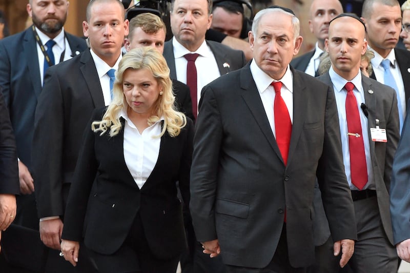 FILE - In this July 19, 2017 file photo, Israeli Prime Minister Benjamin Netanyahu and his wife Sara in the garden of Dohany Street Synagogue in Budapest, Hungary, Wednesday, July 19, 2017. With a slew of corruption scandals closing in on him, Netanyahu is increasingly dropping what remains of his statesmanlike persona in favor of nationalist rhetoric popular with his base. According to one report, his wife Sara is headed toward an indictment for fraud regarding their household expenses. (Zoltan Mathe/MTI via AP, File)