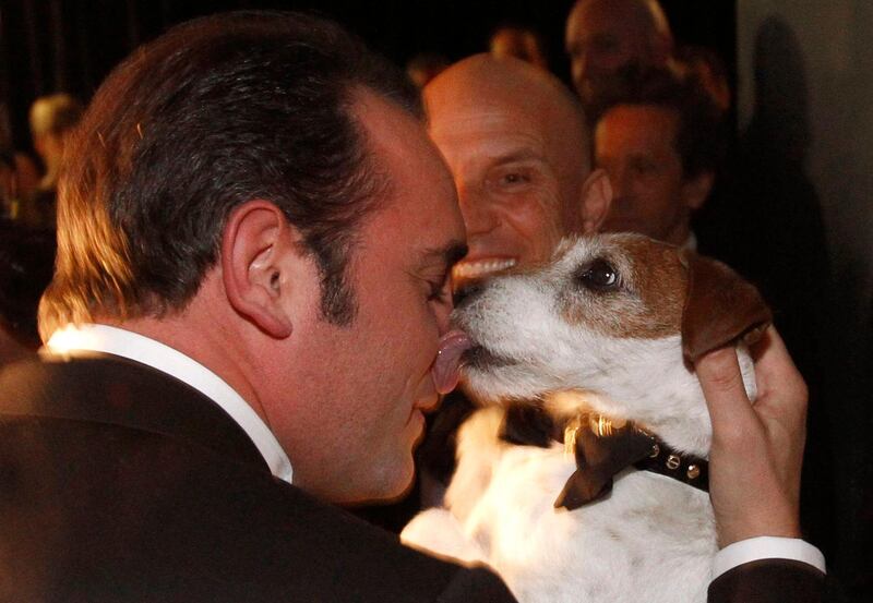 Jean Dujardin holds Uggie after accepting the Oscar for best picture for “The Artist” at the 84th Academy Awards on Sunday, Feb. 26, 2012, in the Hollywood section of Los Angeles. (AP Photo/Chris Carlson) *** Local Caption ***  APTOPIX 84th Academy Awards Insider Backstage.JPEG-09a0e.jpg