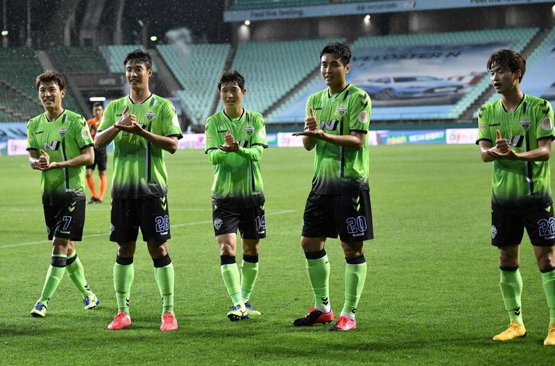 Lee Dong-gook and his teammates gesture a sign of 'respect' as he celebrates his goal against Suwon Samsung Bluewings. AFP