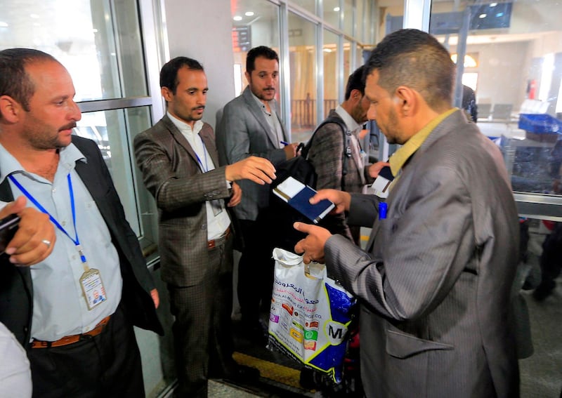 The guardian of a Yemeni child being evacuated on a UN aircraft shows their travel documents at Sanaa International Airport bound for the Jordanian capital Amman to receive medical treatment there.   AFP