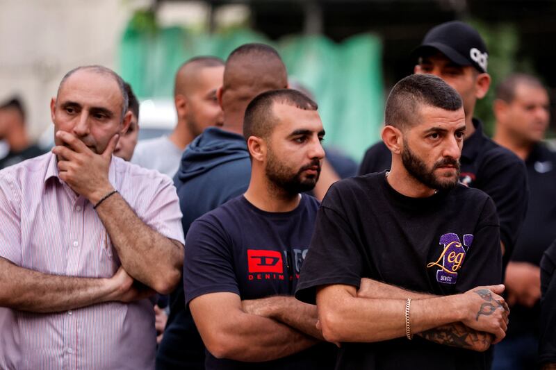 Bystanders near a car wash in Nazareth where five men were killed in one of the worst crime-related shootings in Israel's recent history. Reuters