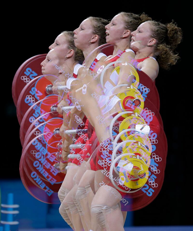 In this multiple exposure photo, Annie Moniqui of Canada competes during the women's 58-kg, group B, weightlifting competition at the 2012 Summer Olympics, Monday, July 30, 2012, in London. (AP Photo/Hassan Ammar)