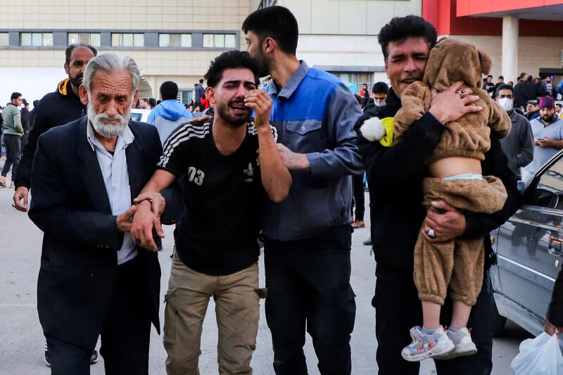 Families of victims of the explosions wait outside the hospital in Kerman. AP