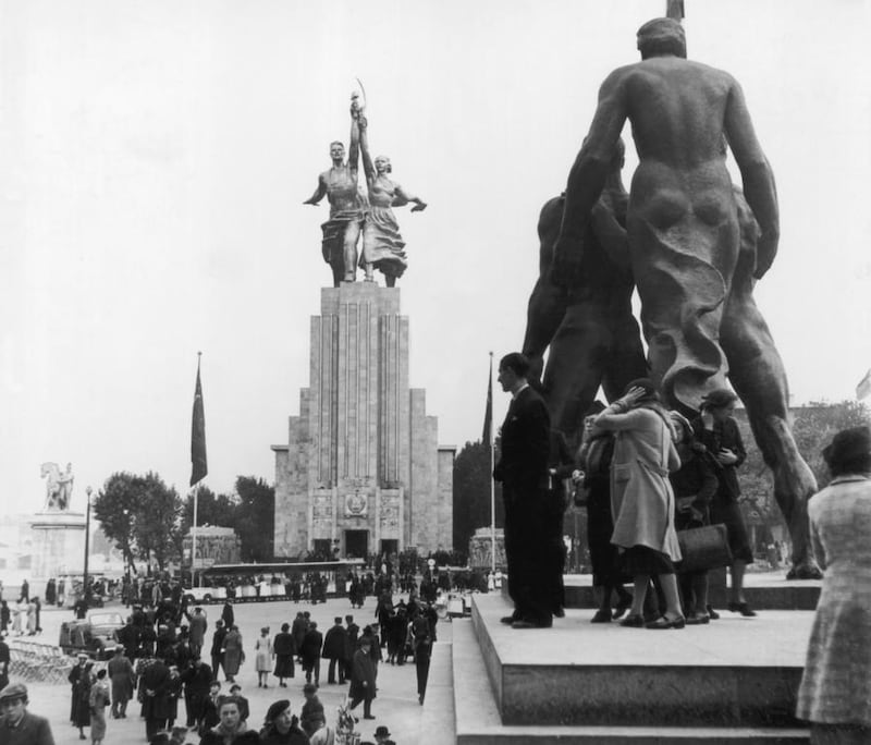 1937: Crowds of people wander among the large statues on display in the Soviet pavilion with the Worker and Kolkhoz Woman exhibit, designed by Vera Mukhina (1889-1953), in the background, at the International Exposition dedicated to Art and Technology in Modern Life, in Paris. Fox Photos/Hulton Archive/Getty Images