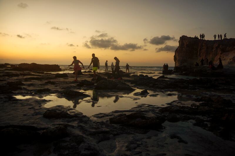 Egyptians on holiday walk at Cleopatra Beach, in the Mediterranean city of Marsa Matrouh. AP