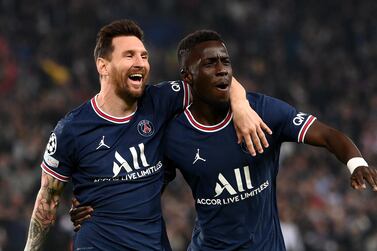 Paris Saint-Germain's Senegalese midfielder Idrissa Gana Gueye (R) celebrates with Paris Saint-Germain's Argentinian forward Lionel Messi (L) after scoring a goal during the UEFA Champions League first round group A football match between Paris Saint-Germain's (PSG) and Manchester City at The Parc des Princes stadium in Paris on September 28, 2021.  (Photo by FRANCK FIFE  /  AFP)