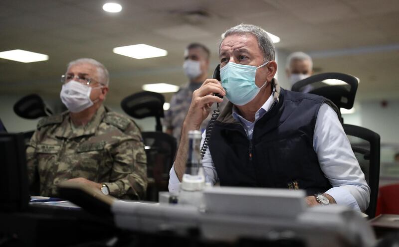 This handout picture released on June 15, 2020 by the Turkish Ministry of Defense press office shows Turkish Defense Minister Hulusi Akar (R) and army commanders wearing face masks as a protection against the coronavirus, following the Operation Claw-Eagle in northern Iraq at Air Force Command Control Center in Ankara.  Turkey's jets have carried out new cross-border air strikes against outlawed Kurdish rebel targets in northern Iraq, the Turkish Defense Ministry said on June 14.  - RESTRICTED TO EDITORIAL USE - MANDATORY CREDIT "AFP PHOTO /Turkish Ministry of Defense Press Office / Arif AKDOGAN " - NO MARKETING - NO ADVERTISING CAMPAIGNS - DISTRIBUTED AS A SERVICE TO CLIENTS
 / AFP / Turkish Ministry of Defense Press Office  / Arif AKDOGAN / RESTRICTED TO EDITORIAL USE - MANDATORY CREDIT "AFP PHOTO /Turkish Ministry of Defense Press Office / Arif AKDOGAN " - NO MARKETING - NO ADVERTISING CAMPAIGNS - DISTRIBUTED AS A SERVICE TO CLIENTS

