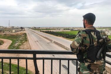 A Syrian army soldier stands overlooking a motorway in the town of Saraqib in the northwestern Idlib province on March 6, 2020, as government forces assumed control over it. / AFP / -