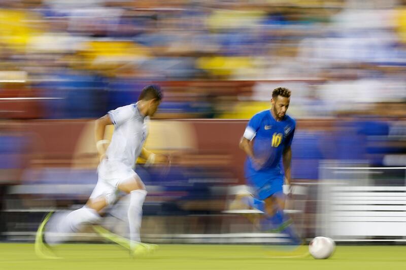 Brazil forward Neymar dribbles the ball as El Salvador defender Roberto Dom’nguez chases him during an international friendly soccer match at FedEx Field in Landover, US. Geoff Burke/Reuters