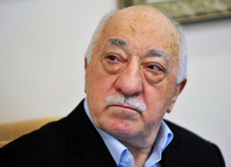FILE - In this July 2016 file photo, Islamic cleric Fethullah Gulen speaks to members of the media at his compound in Saylorsburg, Pa. Two men involved in a Turkish lobbying campaign led by former National Security Adviser Michael Flynn have been charged with illegally lobbying in a case related to special counsel Robert Mueller's investigation. The two worked throughout 2016 to seek ways to have cleric Fethullah Gulen extradited from the U.S. to Turkey. (AP Photo/Chris Post, File)
