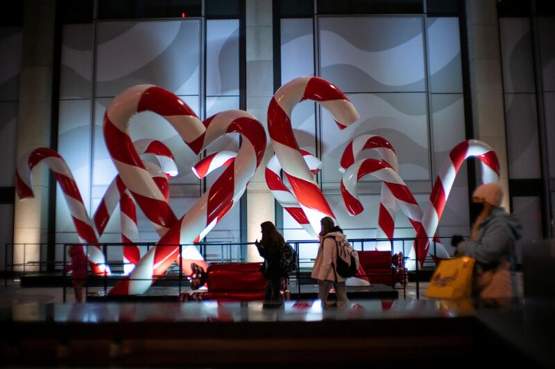 People walk around Christmas decorations as the global outbreak of the coronavirus disease (COVID-19) continues, in New York City, U.S. REUTERS