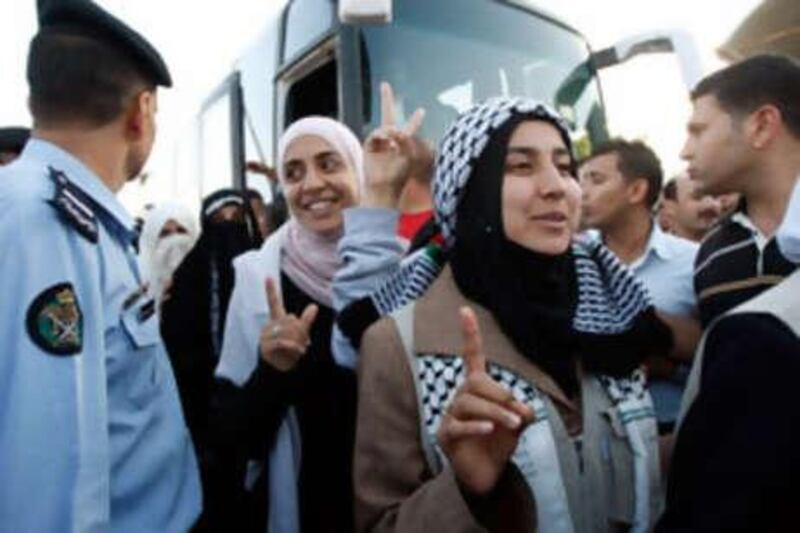 Pro-Palestinian activists who were aboard the Gaza-bound aid flotilla raided by Israel cross the King Hussein Bridge in Shuneh, west of Amman, Jordan from the Israeli-controlled Allenby Bridge.