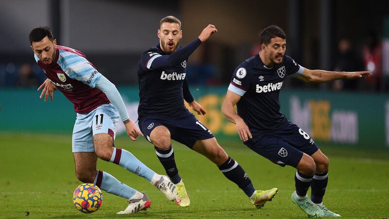 Burnley midfielder Dwight McNeil dribbles the ball away from West Ham players Nikola Vlasic and Pablo Fornal. AFP