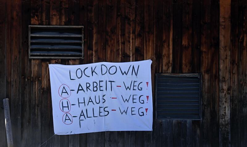 A banner reading "Lockdown - work away, home away, everything gone" is seen at a barn in the small Bavarian village of Schliersee, southern Germany. AFP