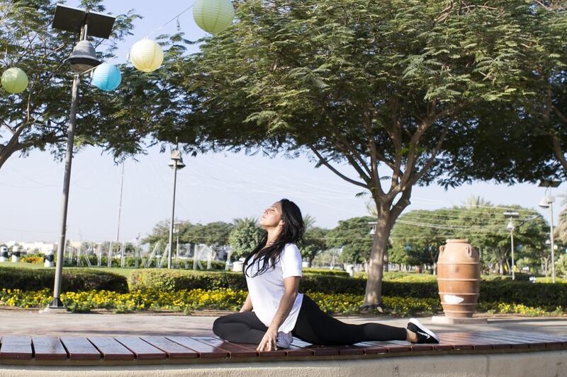 Yoga instructor Dareen Abdullah, wearing Lululemon activewear, at Barsha Pond Park, Dubai. She spends up to Dh4,000 a month on fitness brands, making aesthetics a priority. Reem Mohammed / The National