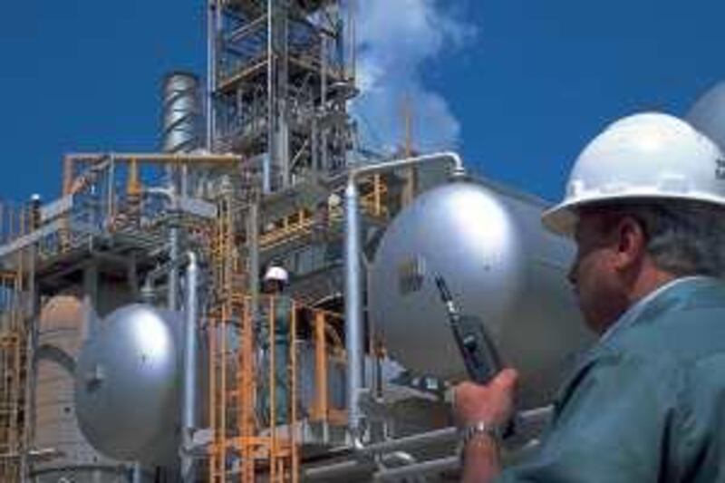 ADNOC FACILITIES

COURTESY ADNOC *** Local Caption *** Man with phone at umm al nar refinery