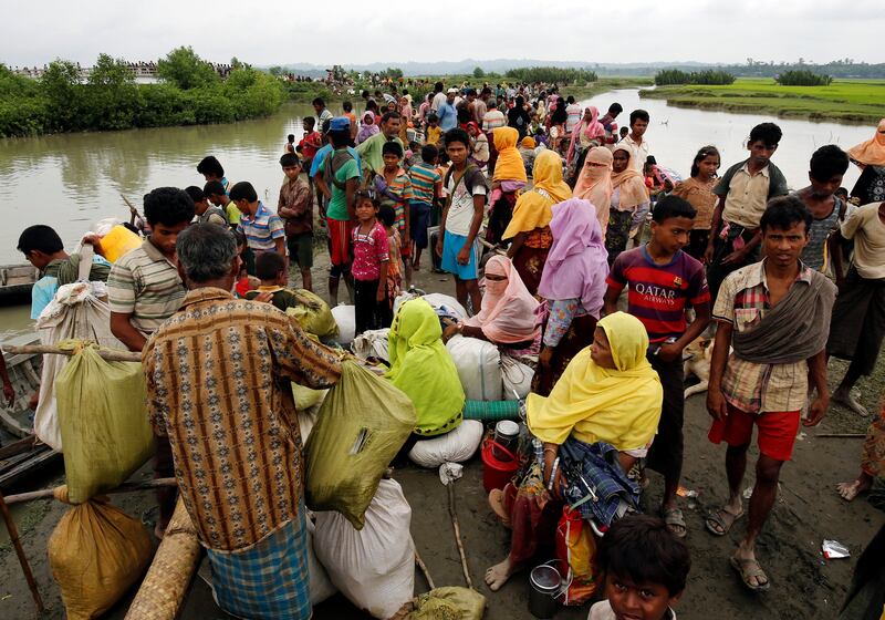 Rohingya refugees are seen waiting for a boat to cross the border through the Naf river in Maungdaw, Myanmar, September 7, 2017. REUTERS/Mohammad Ponir Hossain
