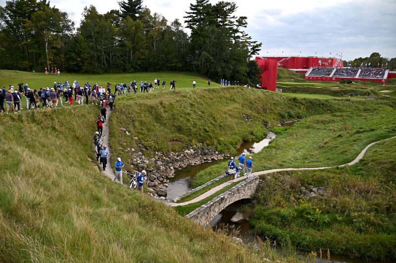 Team Europe's Jon Rahm and Tyrrell Hatton make their way to the eighteenth green. Getty