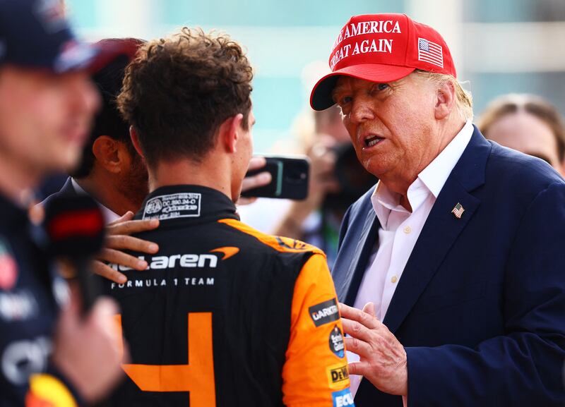 Former US President Donald Trump talks with Lando Norris after the Miami Grand Prix. AFP
