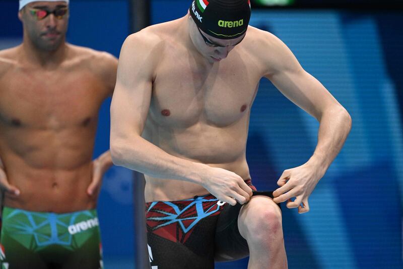 Hungary's Kristof Milak adjusts his swim trunks ahead of the final of the men's 200m butterfly.