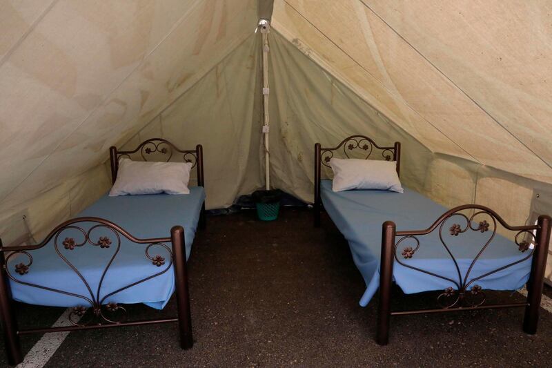 A picture shows extra beds set up in tents in the yard of a Red Crescent Society building hosting a hospital opened by the governor of Hebron and equipped with modern appliances, to receive patients affected by the coronavirus Covid-19 in the village of Halhul, near the city of Hebron in the occupied West Bank.   AFP