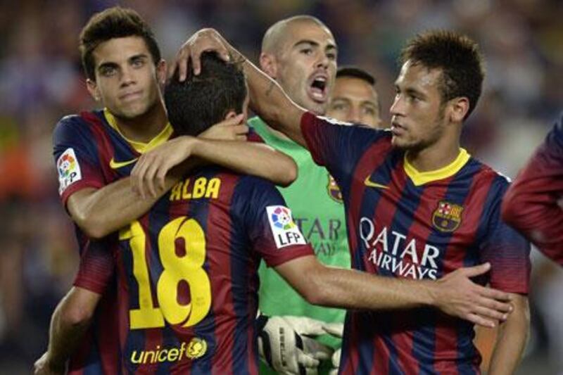 Victor Valdes, centre, the Barcelona goalkeeper, was instrumental in his club's win. Lluis Gene / AFP