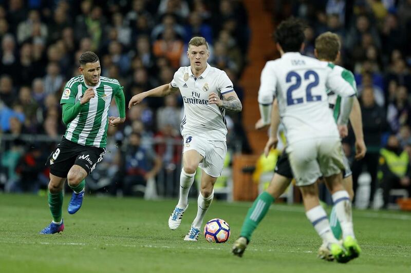 Real Madrid’s Toni Kroos, second left, fights for the ball with Real Betis’ Arnaldo Sanabria, left. Francisco Seco / AP Photo