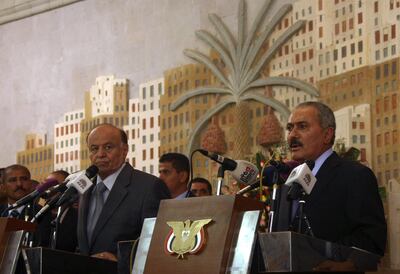 Yemen's former president Ali Abdullah Saleh, who stepped down after 33-years at the helm, addresses a ceremony at the presidential palace, formally handing power to his deputy, and now president Abdrabuh Mansur Hadi (L) in the Yemeni capital Sanaa, on February 27, 2012. AFP PHOTO/ MOHAMMED HUWAIS / AFP PHOTO / MOHAMMED HUWAIS