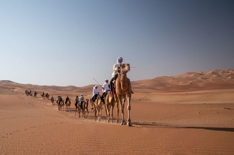 The caravan of camel trekkers.