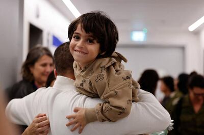 Avihai Brodetz holds his youngest child Oria at an Israeli medical facility after their release by Hamas. AFP