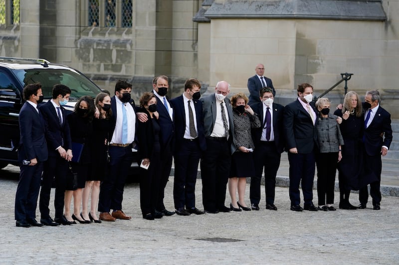 Family members of the former secretary of state stand together outside the cathedral. EPA