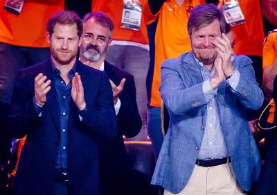 Prince Harry and King Willem-Alexander of the Netherlands applaud the action at the wheelchair basketball final. AFP