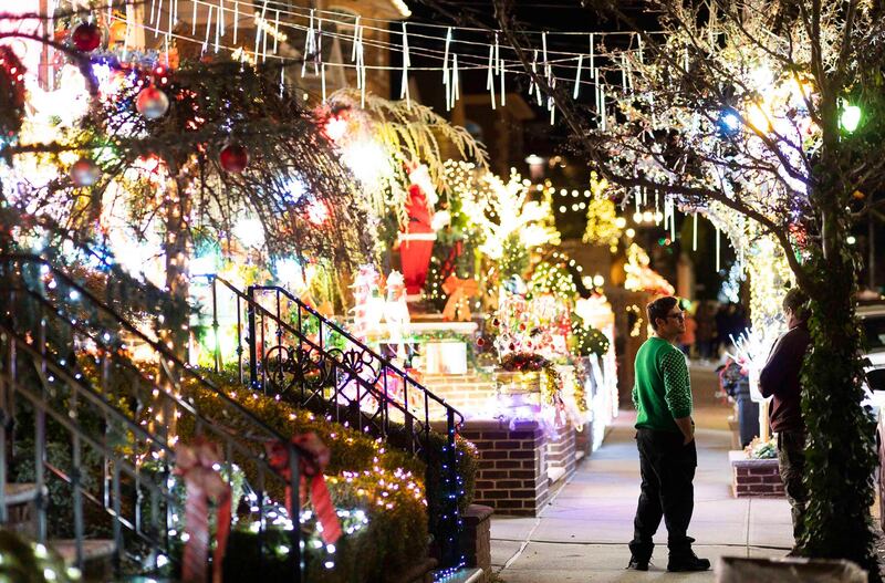 People look at a house decorated in Christmas lights in the Dyker Heights neighborhood of Brooklyn, New York, USA. Dyker Heights is know for its elaborate Christmas light displays.  EPA