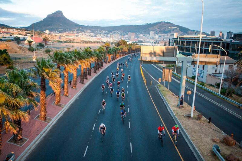 Riders pass a scenic view of the city of Cape Town and Signal Hill during the 40th edition of the Cape Town Cycle Tour. Wikus de Wet / AFP