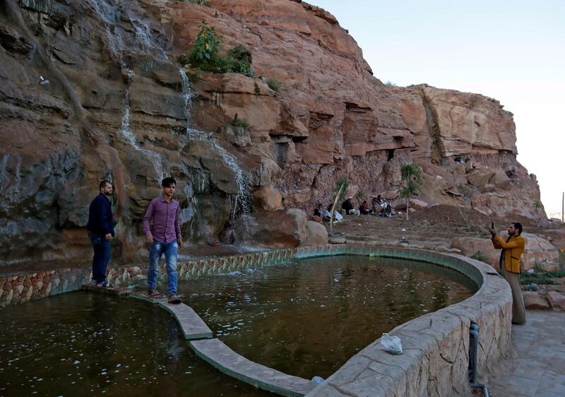 Yemenis enjoy a visit to an artificial waterfall in Sanaa, Yemen.  EPA