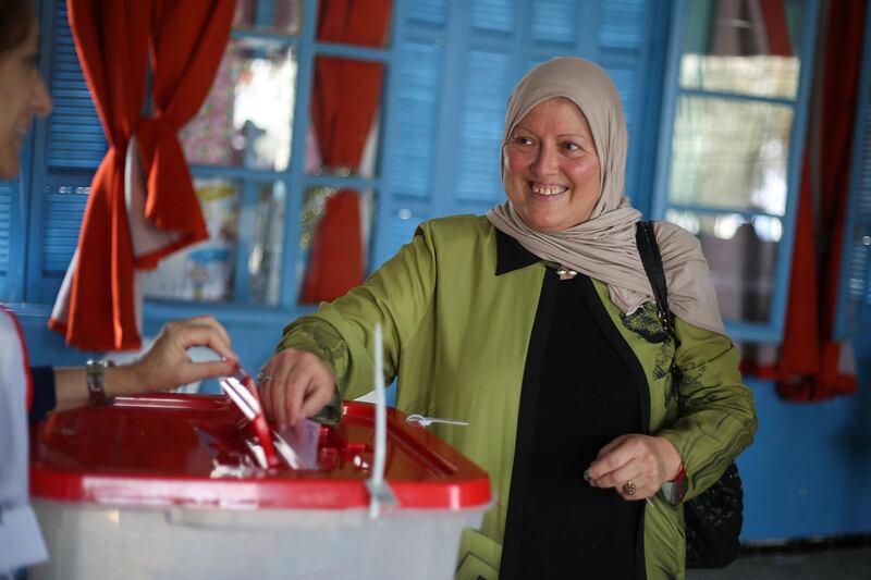 A woman casts her vote at a polling station during a second round runoff of a presidential election in Tunis, Tunisia October 13, 2019. REUTERS/Amine Ben Aziza    NO RESALES. NO ARCHIVES