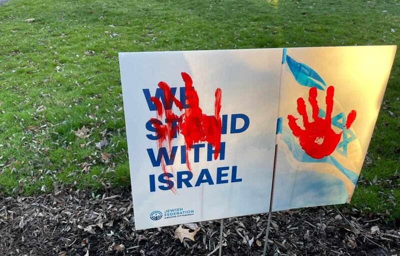 A blood-like handprint is painted on a lawn sign showing support for Israel in Squirrel Hill. Joshua Longmore / The National