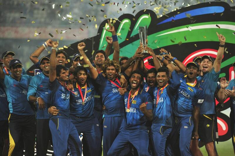 Sri Lanka's players celebrate with the trophy after winning the ICC Twenty20 World Cup cricket title after beating India at the Sher-E-Bangla National Cricket Stadium in Dhaka April 6, 2014. REUTERS/Stringer (BANGLADESH - Tags: SPORT CRICKET TPX IMAGES OF THE DAY)