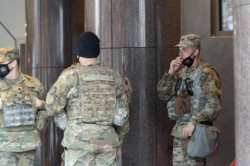 Members of the National Guard gather outside the Grand Hyatt Hotel in Washington. Willy Lowry / The National