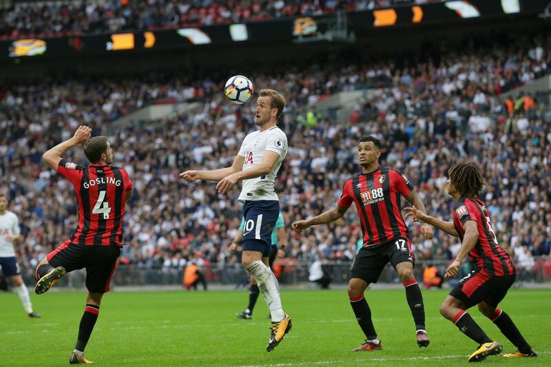 Tottenham's Harry Kane, second left, competes for the ball with Bournemouth's Dan Gosling, left, Joshua King, second right, and Nathan Ake during the English Premier League soccer match between Tottenham Hotspur and AFC Bournemouth at Wembley stadium in London, Saturday Oct. 14, 2017. (AP Photo/Tim Ireland)