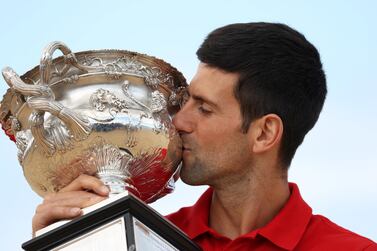 Australian Open champion Novak Djokovic poses with the trophy. Reuters