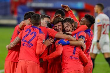 Chelsea's Olivier Giroud celebrates with teammates after scoring his side's third goal with teammates during the Champions League group E soccer match between Sevilla and Chelsea at the Ramon Sanchez Pijuan stadium in Seville, Spain, Wednesday, Dec. 2, 2020. (AP Photo/Angel Fernandez)