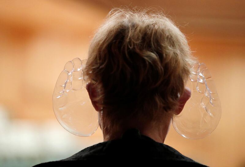 A woman wears orchestra conductor Ivan Fischer's acoustic mask at the Mupa Budapest in Budapest, Hungary, September 11, 2020. Picture taken September 11, 2020. REUTERS/Bernadett Szabo