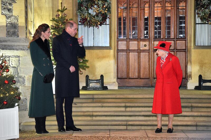 WINDSOR, ENGLAND - DECEMBER 08: Queen Elizabeth II (R) talks with Prince William, Duke of Cambridge, (2L) and Catherine, Duchess of Cambridge, as they wait to thank local volunteers and key workers for the work they are doing during the coronavirus pandemic and over Christmas in the quadrangle of Windsor Castle on December 8, 2020 in Windsor, England.  The Queen and members of the royal family gave thanks to local volunteers and key workers for their work in helping others during the coronavirus pandemic and over Christmas at Windsor Castle in what was also the final stop for the Duke and Duchess of Cambridge on their tour of England, Wales and Scotland. (Photo by Glyn Kirk - WPA Pool/Getty Images)