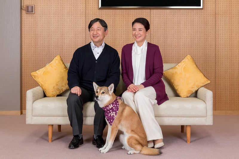 Japan's Crown Princess Masako and her husband Crown Prince Naruhito with their pet dog Yuri at Togu Palace in Tokyo in December 2018. AFP