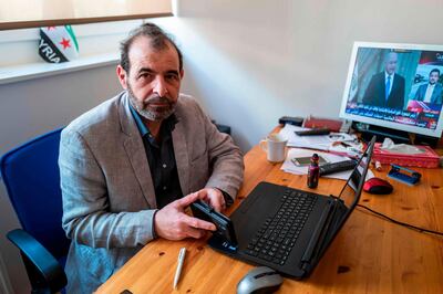 Syrian human rights lawyer Anwar al-Bunni poses in his office in Berlin on April 9, 2020.  When Anwar al-Bunni crossed paths with fellow Syrian Anwar Raslan in a DIY store in Germany five years ago, he recognised him as the man who had thrown him into prison around a decade earlier. On Thursday, April 23, 2020 the two men will face each other in a German court, where Raslan will be one of two alleged former Syrian intelligence officers in the dock accused of carrying out crimes against humanity for Bashar al-Assad's regime.
 / AFP / John MACDOUGALL
