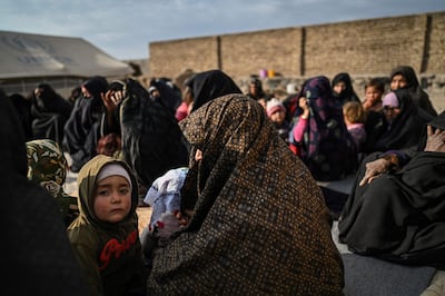 Women wait for staff from Doctors Without Borders (MSF) to check their children for signs of malnutrition, at a camp for internally displaced people on the outskirts of Herat, November 22. AFP