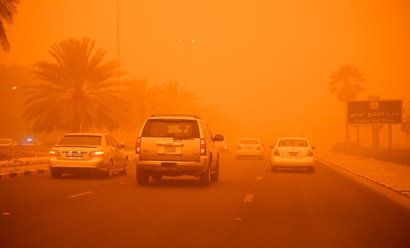 Cars on a road during heavy dust conditions in the Kuwaiti capital. EPA