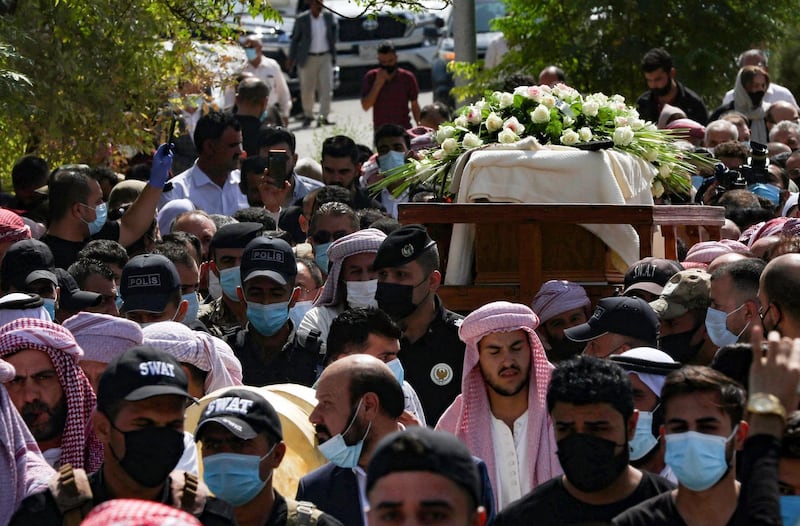 Iraqi Yazidi men carry the casket of Baba Sheikh Khurto Hajji Ismail, supreme spiritual leader of the Yazidi religious minority, during his funeral procession in the Iraqi town of Sheikhan on October 2, 2020. AFP